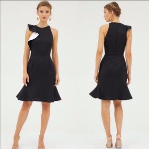 Black cocktail dress with white ruffled sleeve